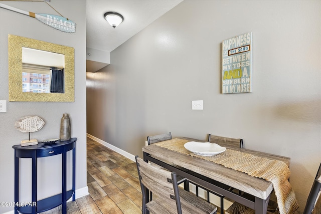 dining space with wood finished floors and baseboards