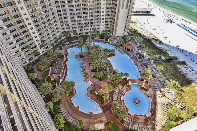 bird's eye view with a water view and a beach view