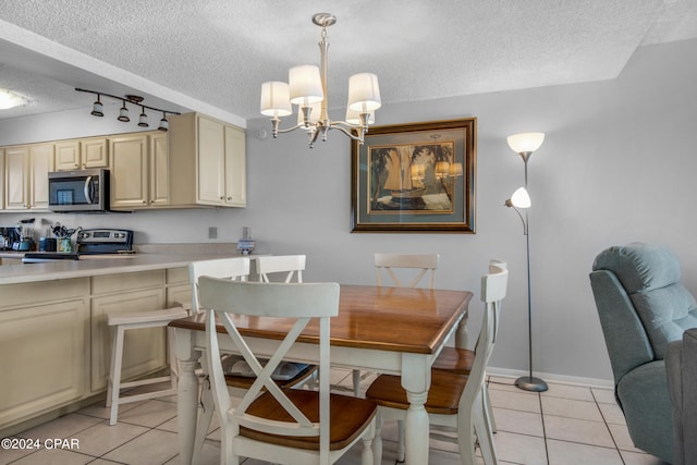 tiled dining space with a chandelier and a textured ceiling