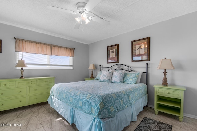 bedroom with ceiling fan and a textured ceiling