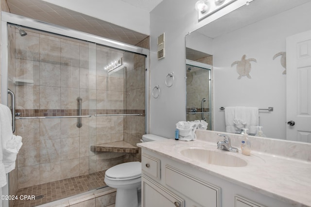 bathroom with walk in shower, tile patterned flooring, vanity, and toilet