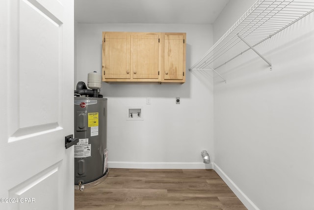 laundry room with electric dryer hookup, hardwood / wood-style flooring, washer hookup, cabinets, and electric water heater