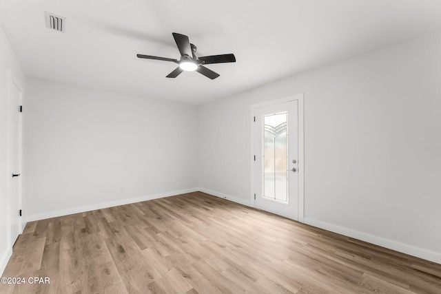 empty room with light hardwood / wood-style flooring and ceiling fan