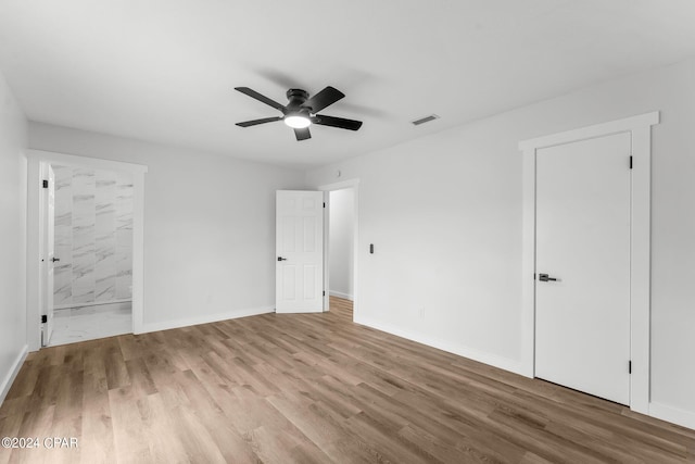 spare room featuring ceiling fan and light hardwood / wood-style flooring