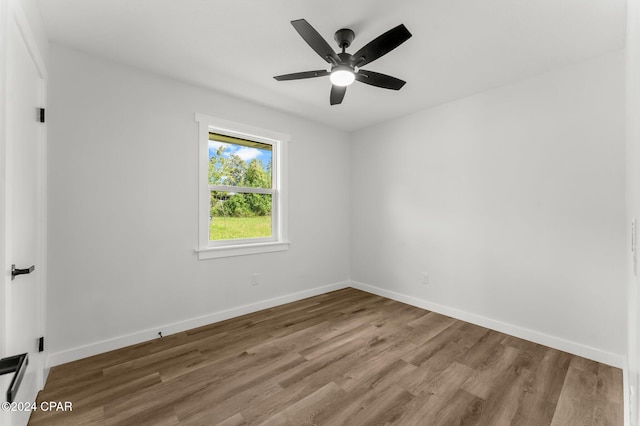 spare room featuring hardwood / wood-style floors and ceiling fan