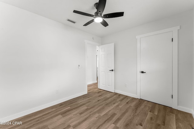 unfurnished bedroom with light hardwood / wood-style flooring and ceiling fan