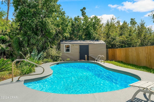 view of swimming pool featuring an outdoor structure