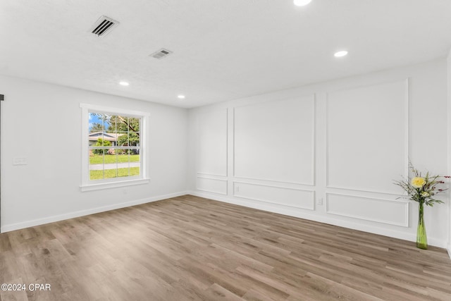 unfurnished room featuring hardwood / wood-style floors