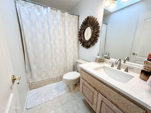 bathroom featuring a textured ceiling, toilet, and vanity