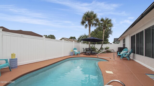 view of swimming pool with a patio area, a fenced backyard, and a fenced in pool