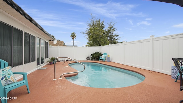 view of pool with a patio area, a fenced backyard, and a fenced in pool