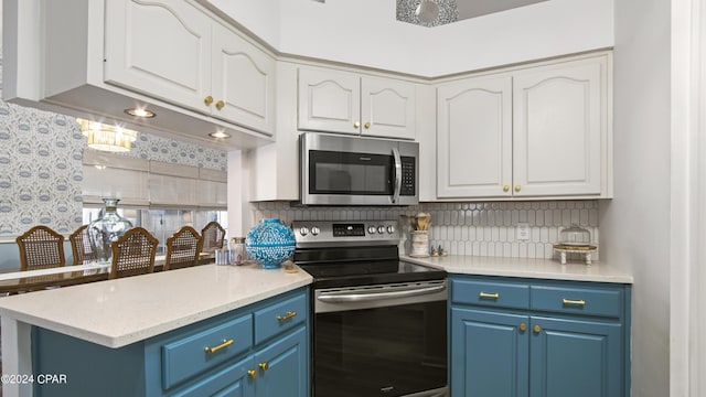 kitchen with blue cabinets, tasteful backsplash, white cabinets, and stainless steel appliances