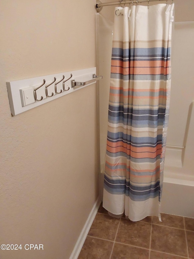 bathroom with shower / tub combo and tile patterned floors