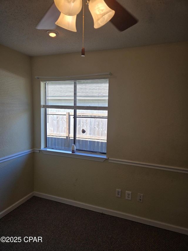 carpeted spare room with ceiling fan