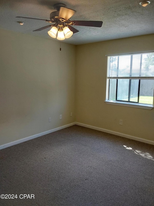 unfurnished room with a textured ceiling, ceiling fan, and carpet