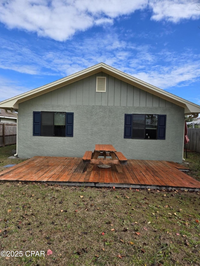 back of house featuring a wooden deck