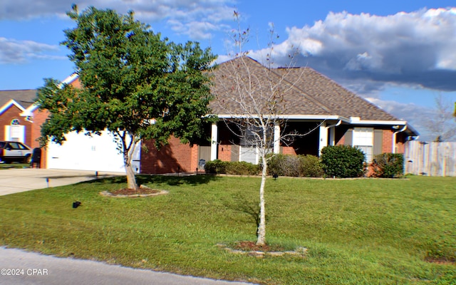 view of front of property featuring a garage and a front yard