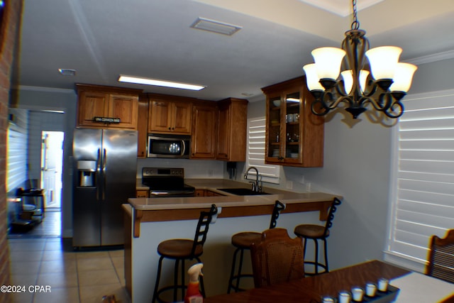 kitchen with ornamental molding, stainless steel appliances, sink, a breakfast bar, and kitchen peninsula