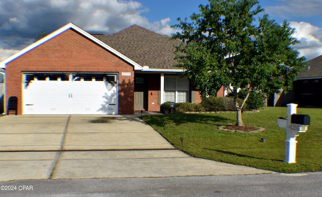 view of front of house with a front yard and a garage