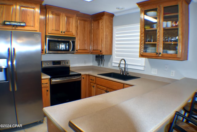 kitchen featuring kitchen peninsula, sink, backsplash, and appliances with stainless steel finishes