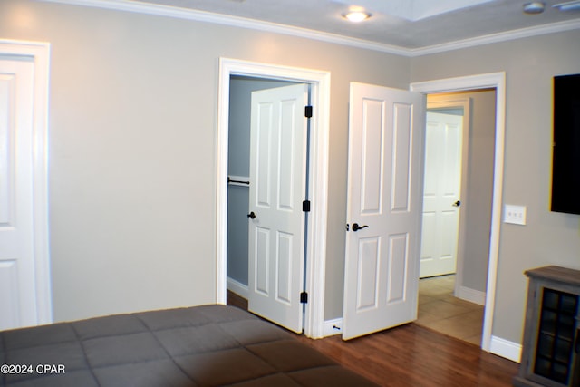 unfurnished bedroom with dark wood-type flooring and crown molding