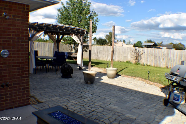 view of patio featuring grilling area and a pergola