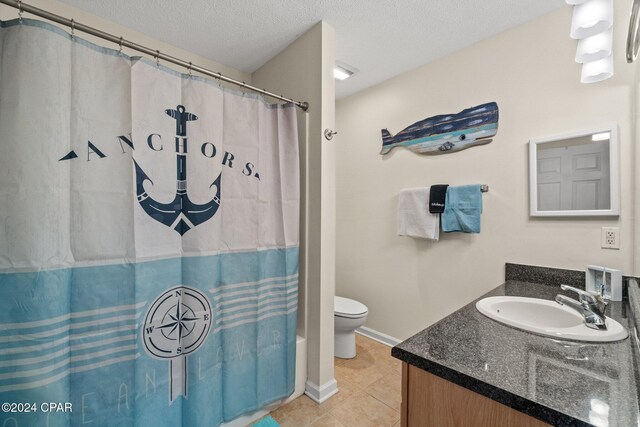 bathroom featuring a textured ceiling, vanity, toilet, and tile patterned floors