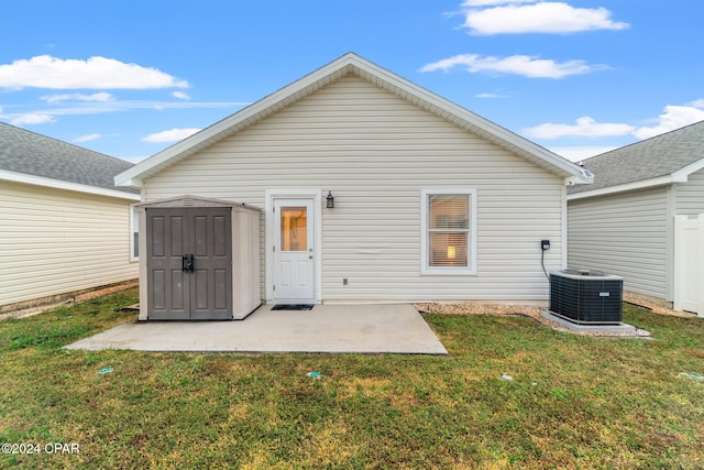 rear view of property featuring a patio, a shed, a lawn, and central air condition unit