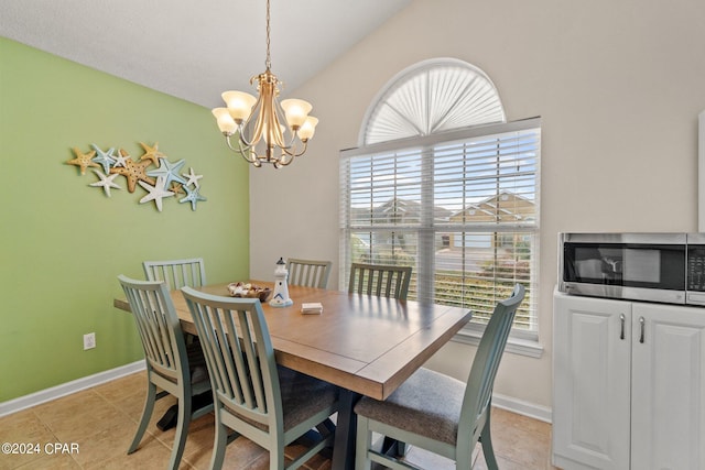 dining space featuring light tile patterned flooring, lofted ceiling, and a chandelier