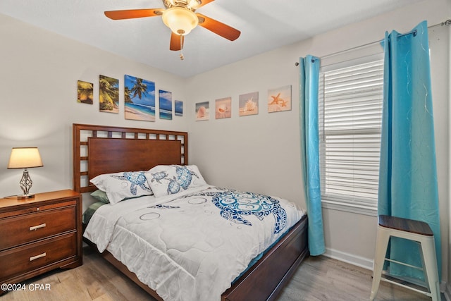 bedroom with light hardwood / wood-style flooring and ceiling fan