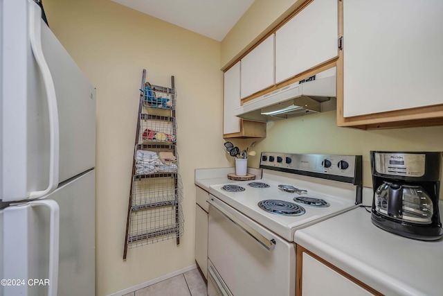 kitchen featuring white cabinetry, light tile patterned flooring, and white appliances