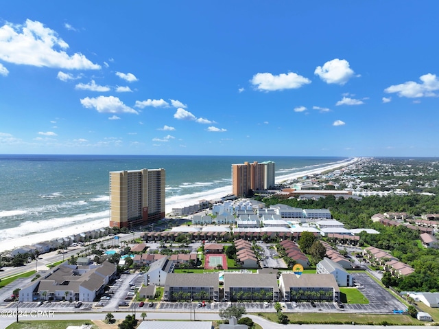 drone / aerial view featuring a water view and a beach view