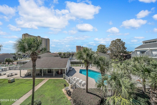 view of pool with a lawn and a patio area