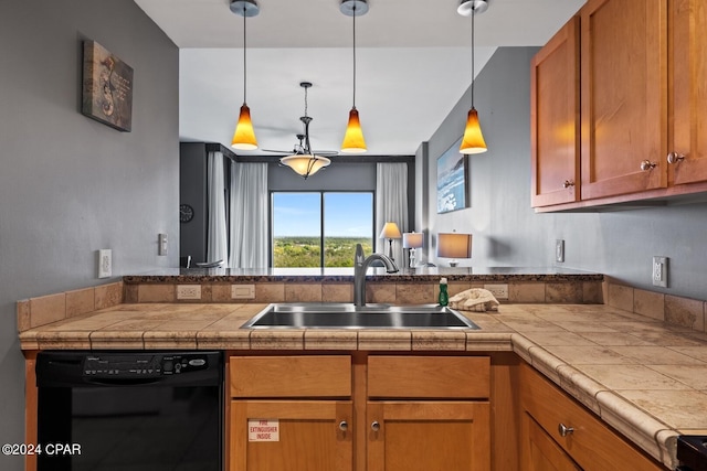 kitchen featuring sink, dishwasher, hanging light fixtures, and tile counters