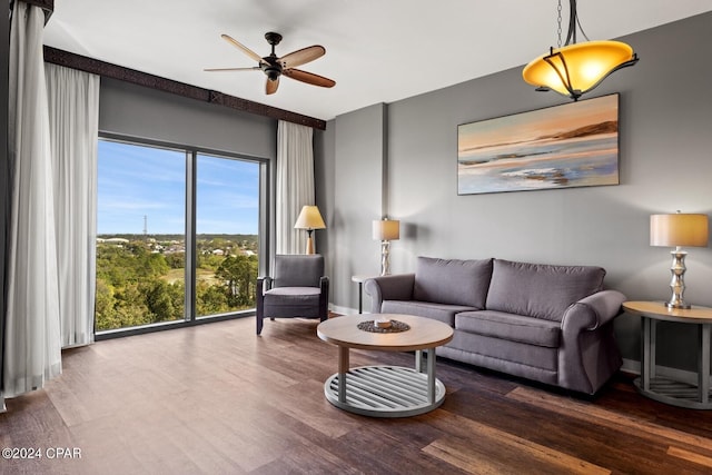 living room featuring wood-type flooring and ceiling fan