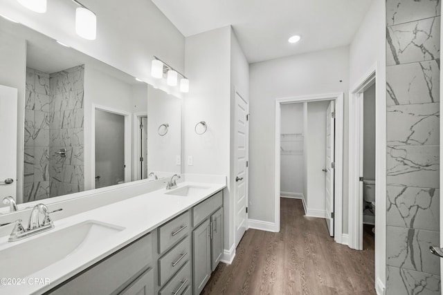 bathroom featuring wood-type flooring, vanity, and toilet