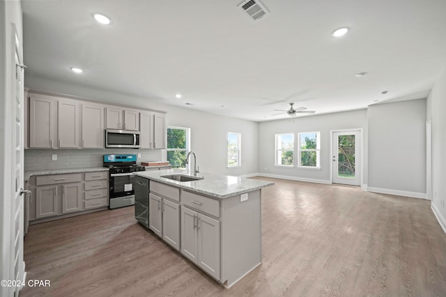 kitchen featuring gray cabinets, appliances with stainless steel finishes, sink, and light hardwood / wood-style floors