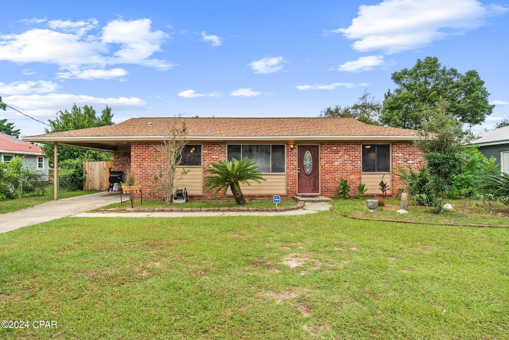 single story home featuring a carport and a front yard