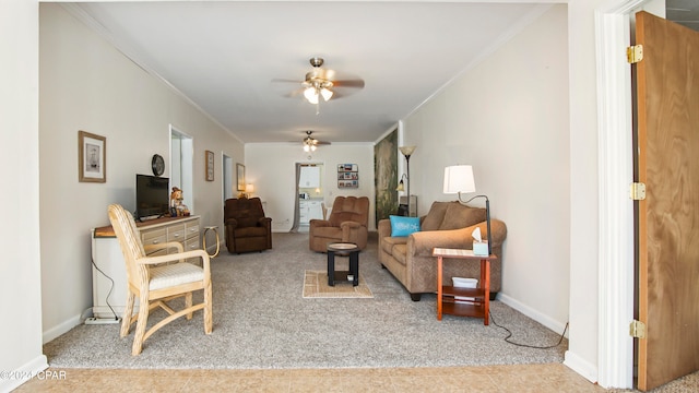 carpeted living room featuring ceiling fan and crown molding