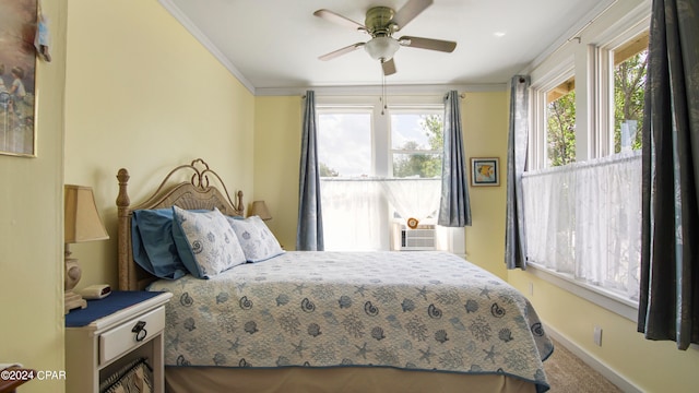 carpeted bedroom featuring ornamental molding and ceiling fan