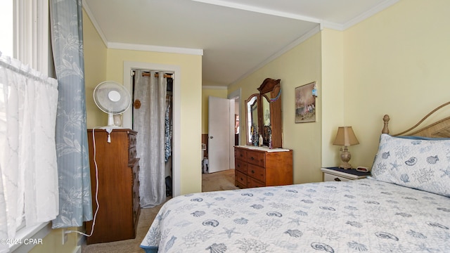 bedroom with ornamental molding and carpet floors