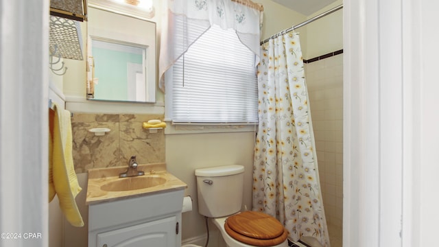 bathroom featuring vanity, toilet, and curtained shower