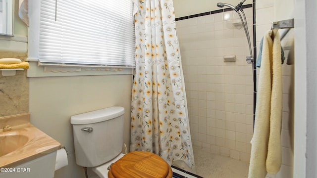 bathroom with vanity, curtained shower, and toilet