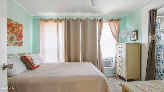 carpeted bedroom featuring cooling unit, ornamental molding, and ceiling fan