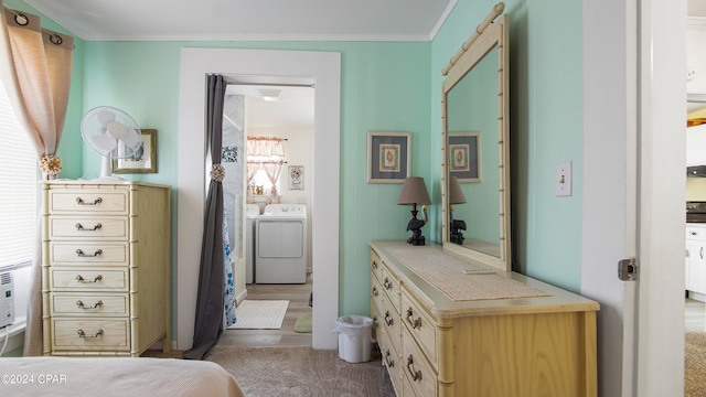 bathroom with crown molding and independent washer and dryer