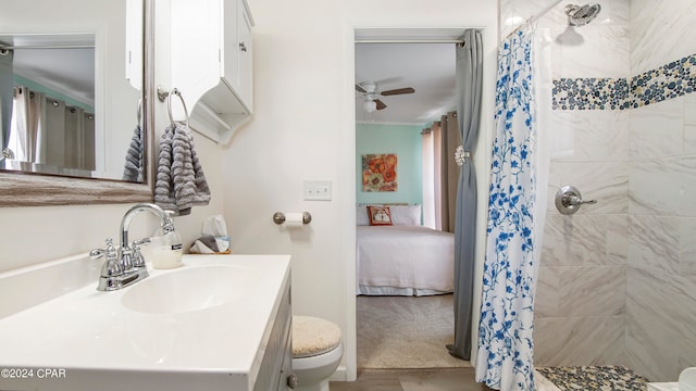 bathroom featuring ceiling fan, vanity, toilet, and curtained shower