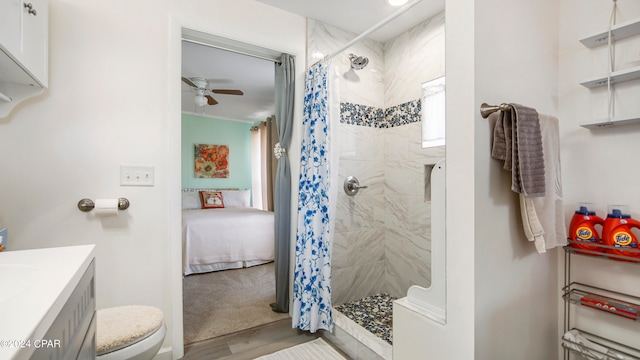 bathroom with vanity, walk in shower, wood-type flooring, ceiling fan, and toilet