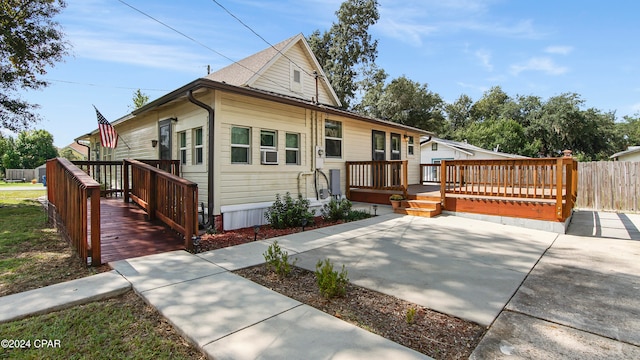 view of front facade with a deck and a patio area