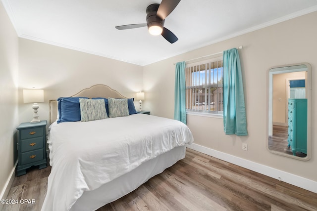 bedroom featuring ceiling fan, hardwood / wood-style flooring, and ornamental molding