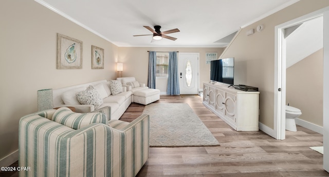 living room featuring crown molding, light wood-type flooring, and ceiling fan